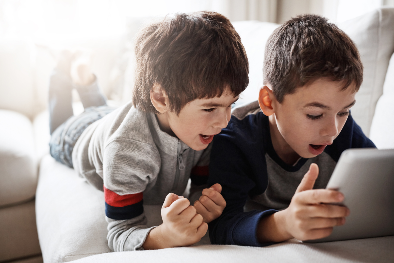 Kids spending their time playing together in tablet